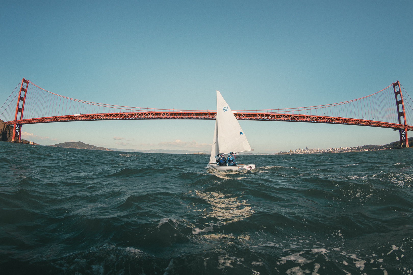 FJ sailboat sailing beneath the Golden Gate Bridge