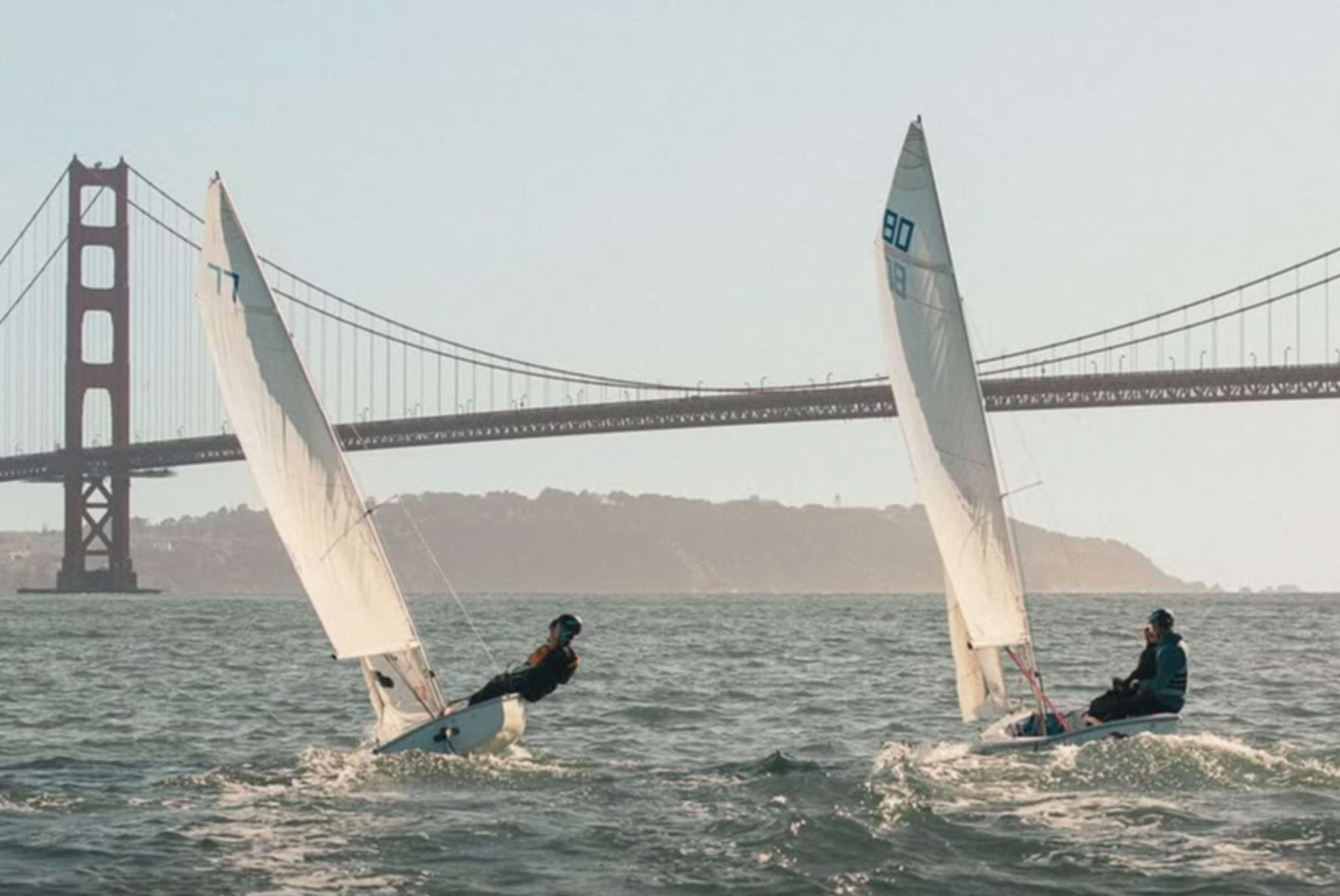 Two FJ sailboats sailing near the Golden Gate Bridge